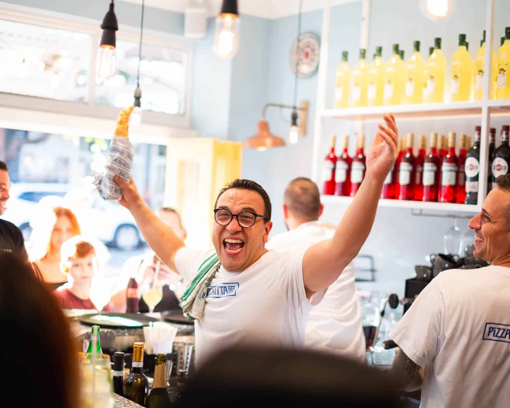 Luigi Esposito smiling in front of Pizza Fritta 180 signage promoting the Surry Hills reopening on August 23