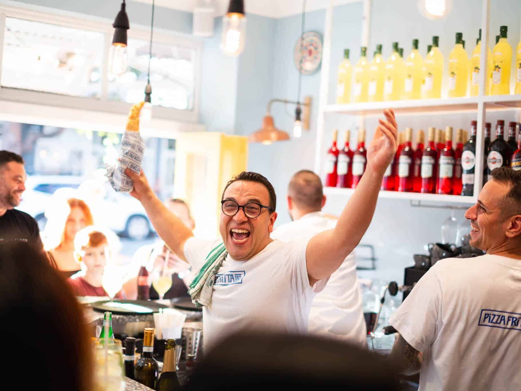 Luigi Esposito smiling in front of Pizza Fritta 180 signage promoting the Surry Hills reopening on August 23