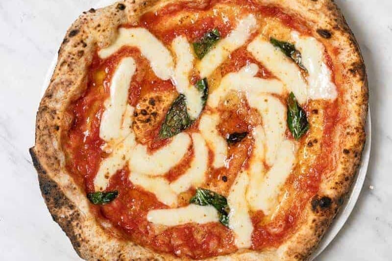 Margherita pizza topped with Solania San Marzano tomatoes, Fior di Latte, Pecorino Romano, Grana Padano DOP, fresh basil, and EVOO at Pizza Fritta 180