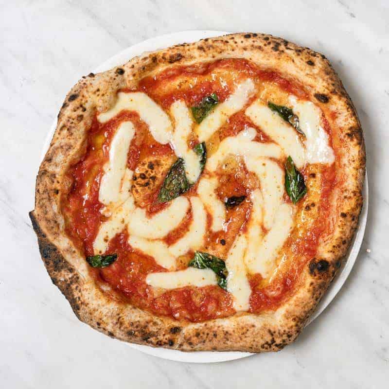 Margherita pizza topped with Solania San Marzano tomatoes, Fior di Latte, Pecorino Romano, Grana Padano DOP, fresh basil, and EVOO at Pizza Fritta 180
